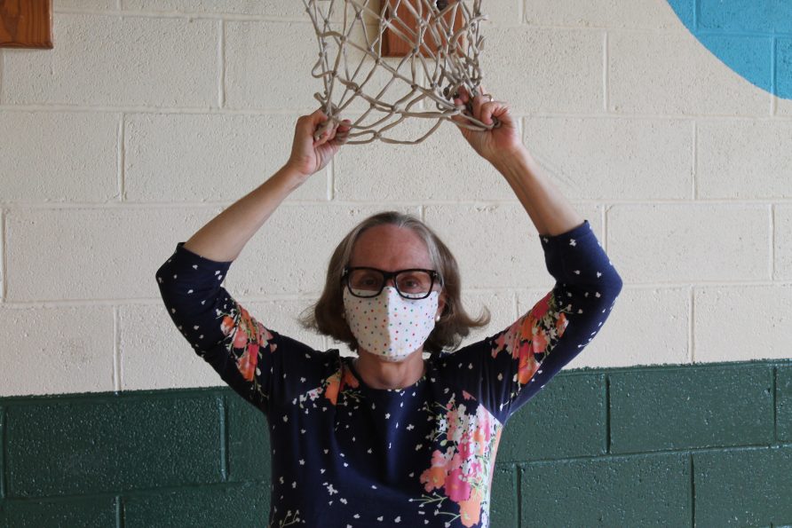 Miss Karen holding basketball net